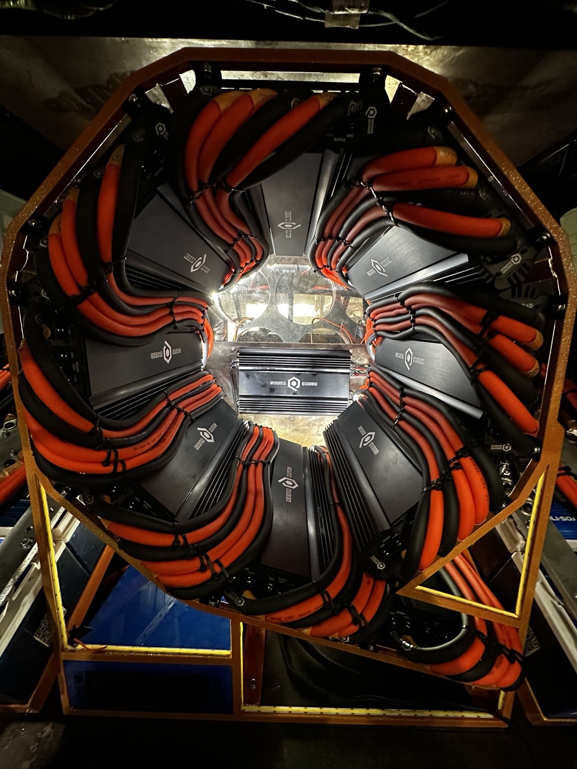 Circular amplifier rack with carefully routed orange and black wiring
