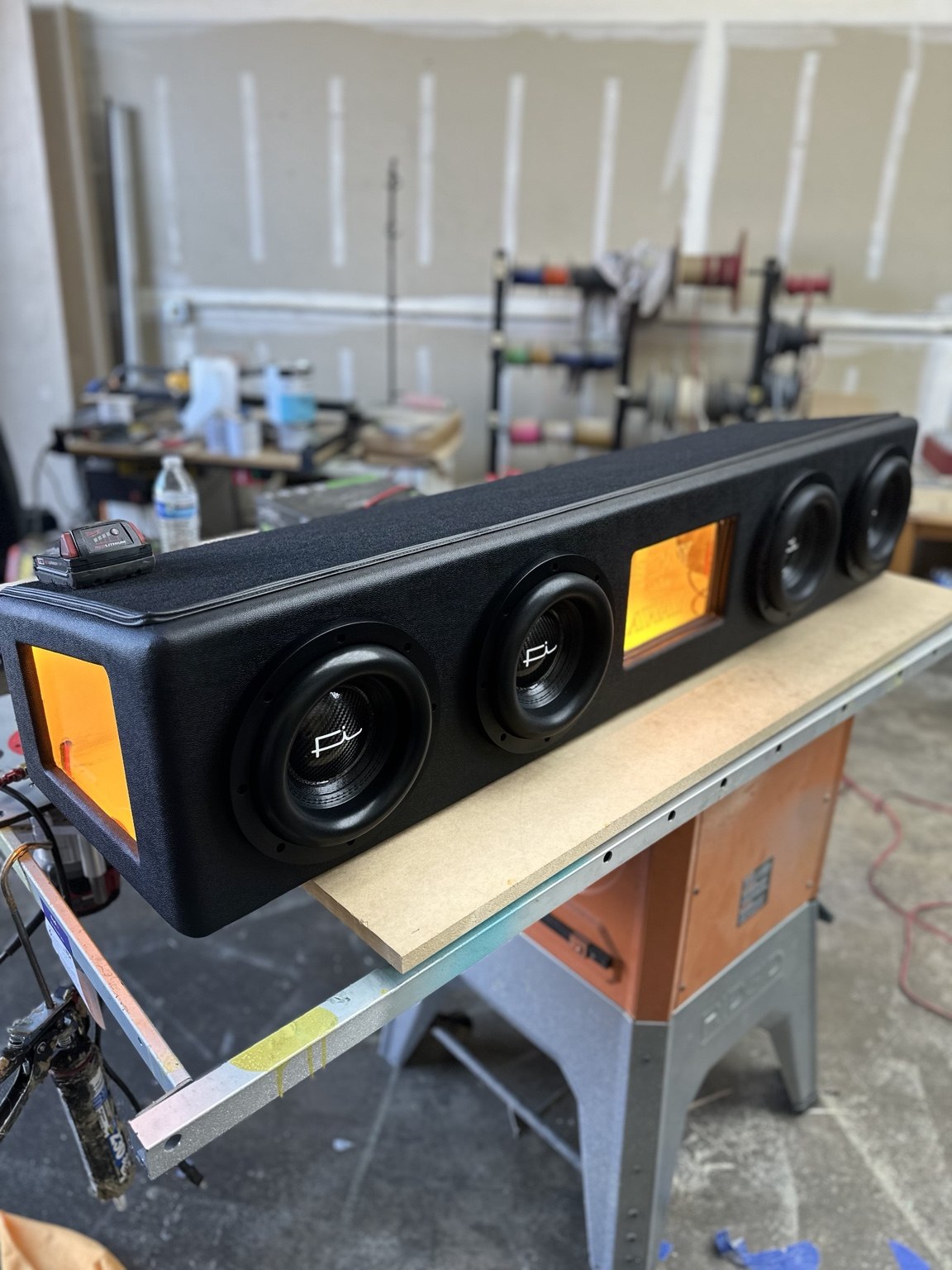 Custom upholstered panel with multiple speakers and illuminated center detail