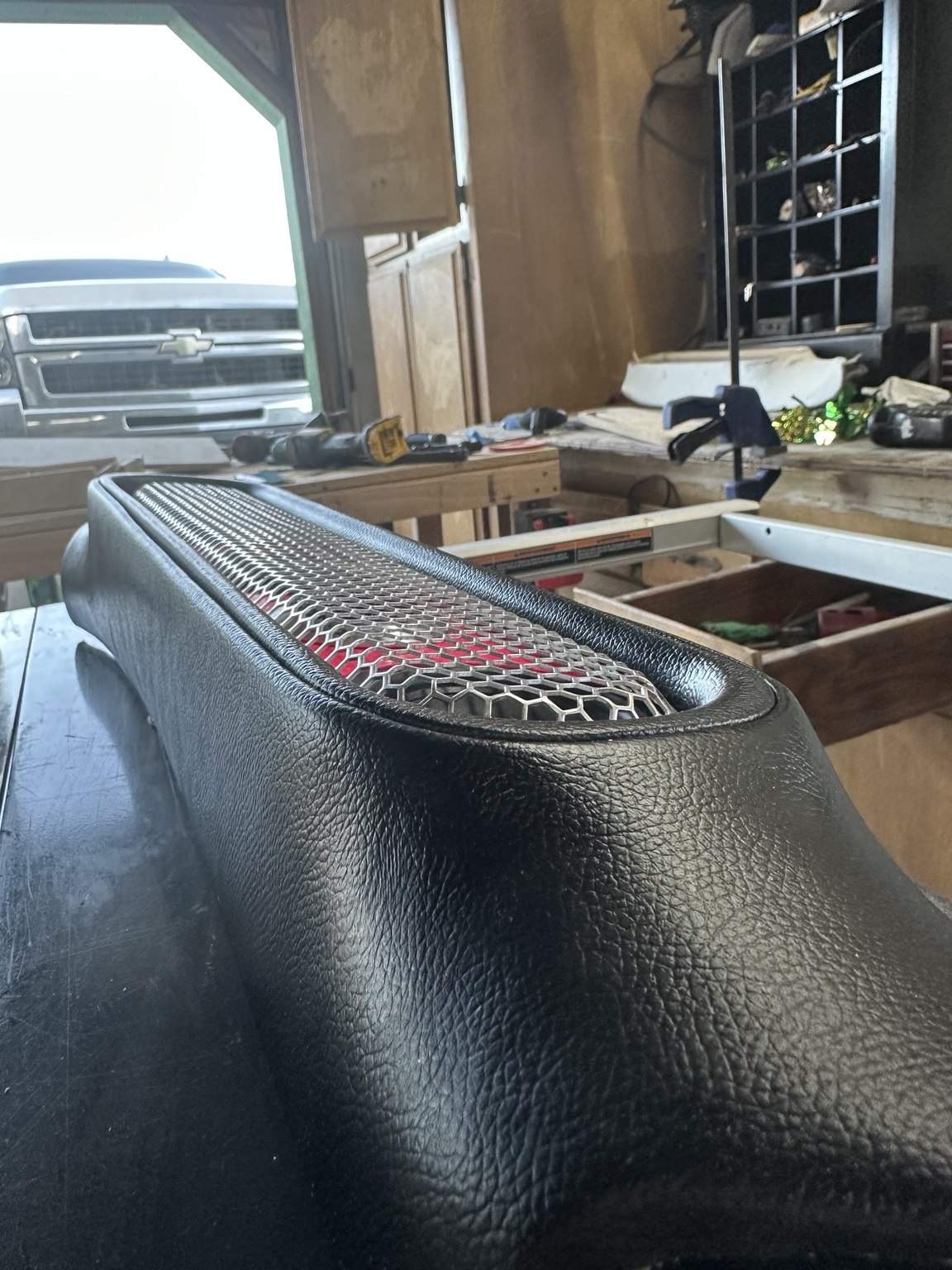 Close-up of custom upholstered speaker trim with mesh grille