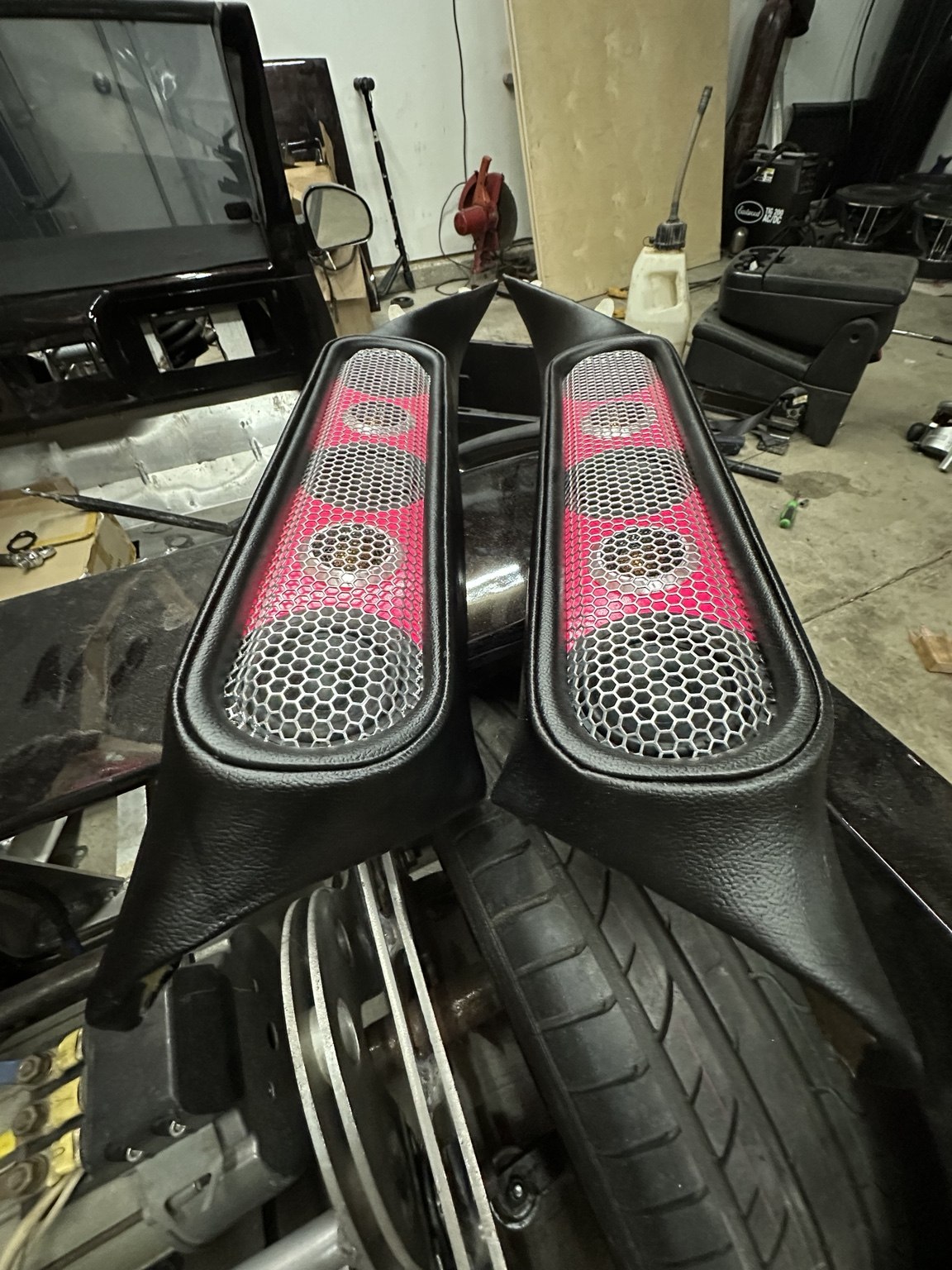 Pair of custom speaker panels with mesh grilles and pink accents